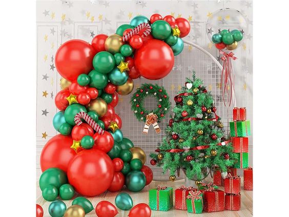 Red, gold, and green balloon arch with foil stars and candy canes