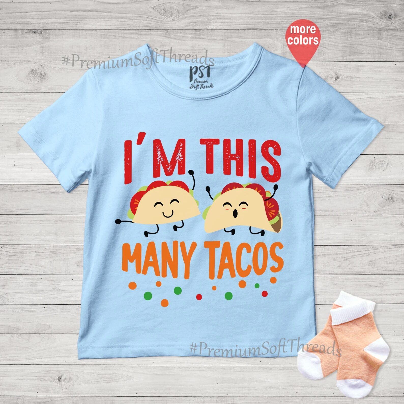 T-shirt with text I'm this many tacos. Two cartoon tacos with faces, feet, and arms smile and jump.